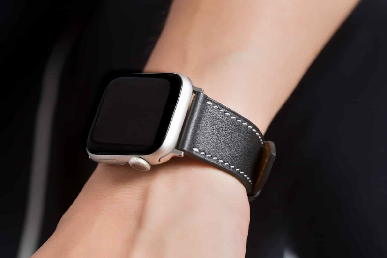 Leather Apple Watch strap worn on the wrist, showing the fit of the adapter against the case, made by AKC