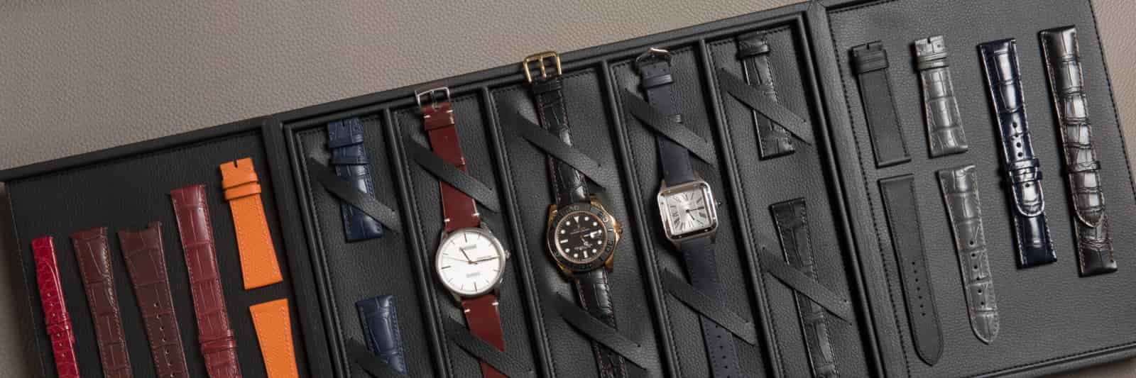 Three watches fitted with leather straps from a single private-label programme, photographed flat from above, produced by AKC